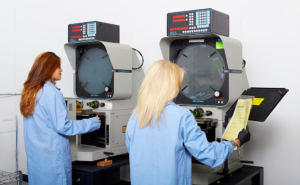 two women standing at machines